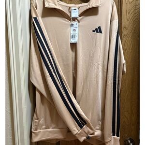 Adidas light weight jacket with black stripes. New with tags.